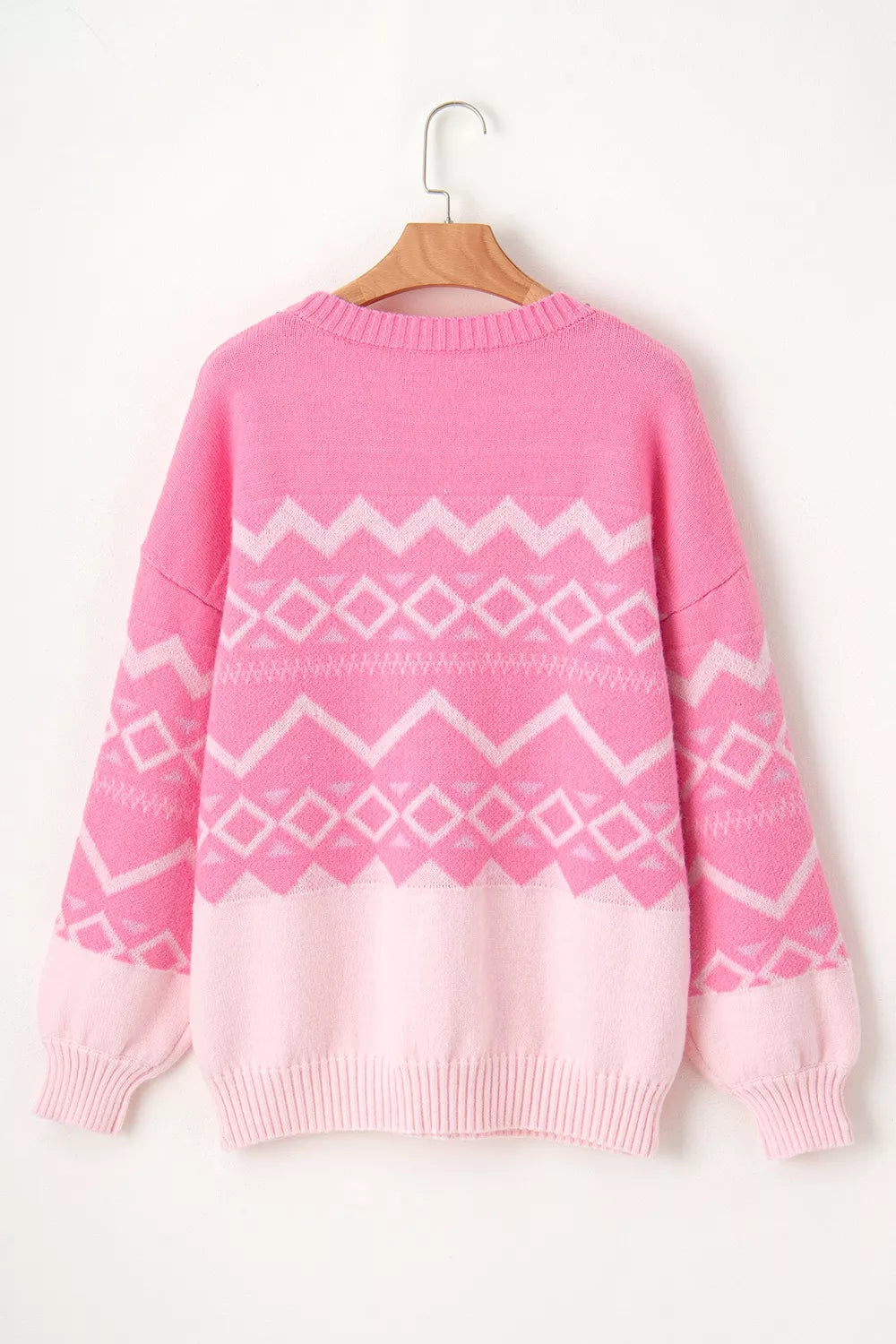 Geometric patterned long sleeve sweater by Tikibella™, featuring vibrant colors and a cozy knit design.