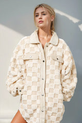 Fuzzy checkered shacket with button-up front and relaxed fit by Tikibella™, showcased in a stylish outfit.