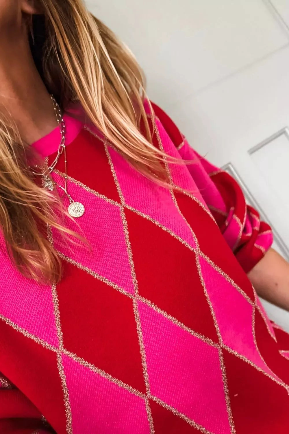 Argyle pattern long sleeve sweater in vibrant colors by Tikibella™, displayed on a neutral background.