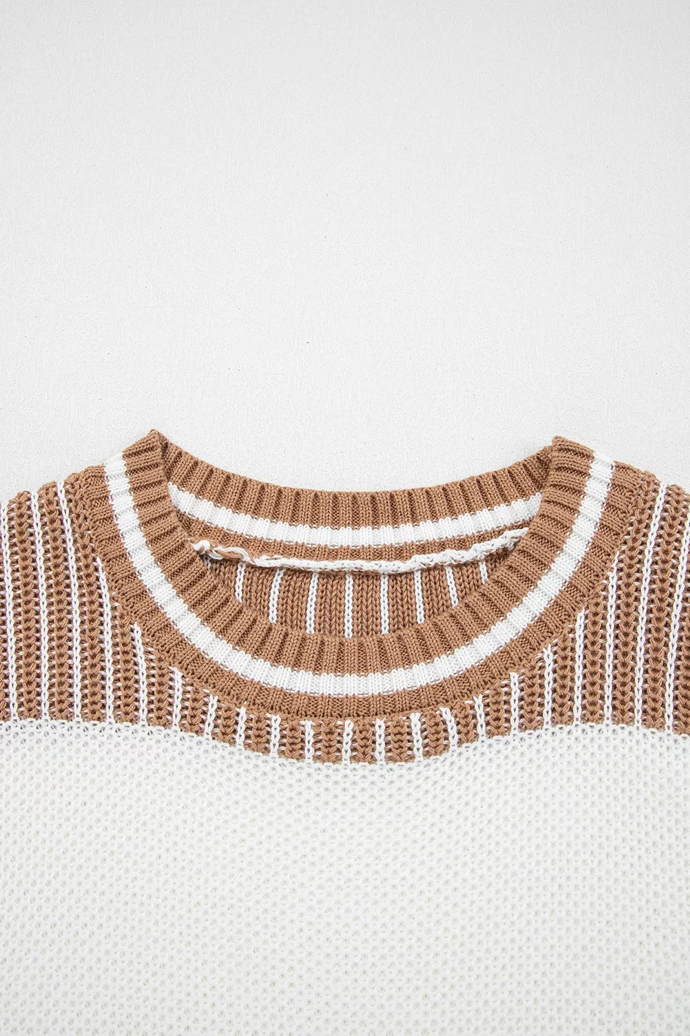 Striped knit long sleeve sweater by Tikibella™, featuring a cozy design and vibrant color patterns.