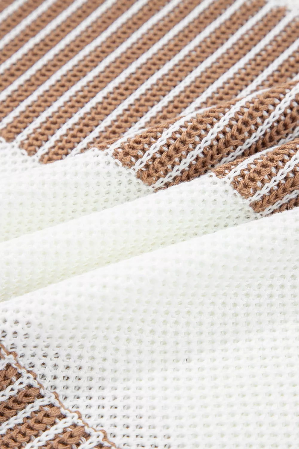 Tikibella™ striped knit long sleeve sweater featuring a cozy design and vibrant color patterns.