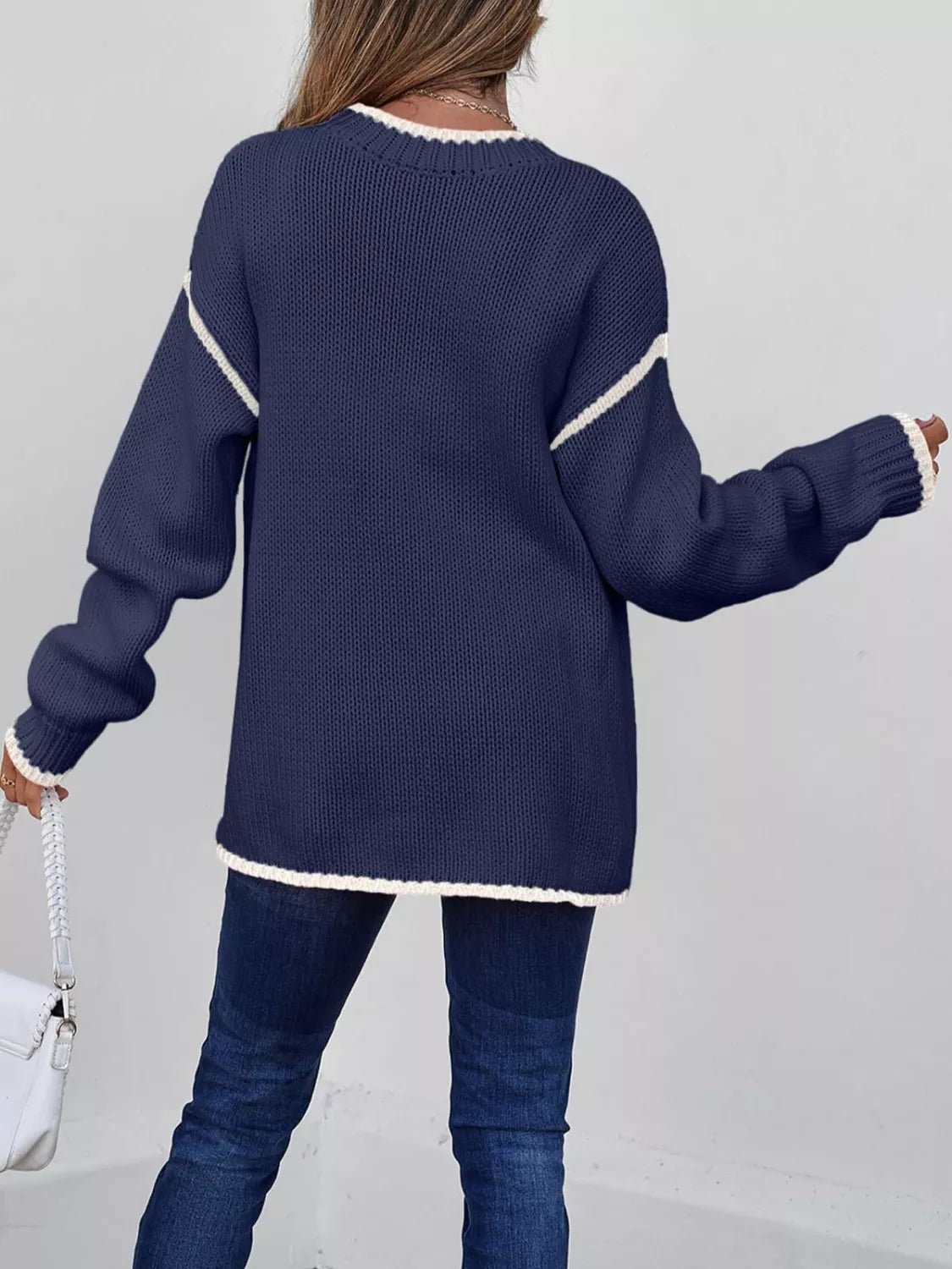 Tikibella™ contrast trim round neck sweater in a cozy knit, featuring a stylish design and vibrant color accents.