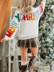 Drop shoulder HOHOHO MERRY CHRISTMAS holiday sweater by Tikibella™ in festive colors and cozy knit design.