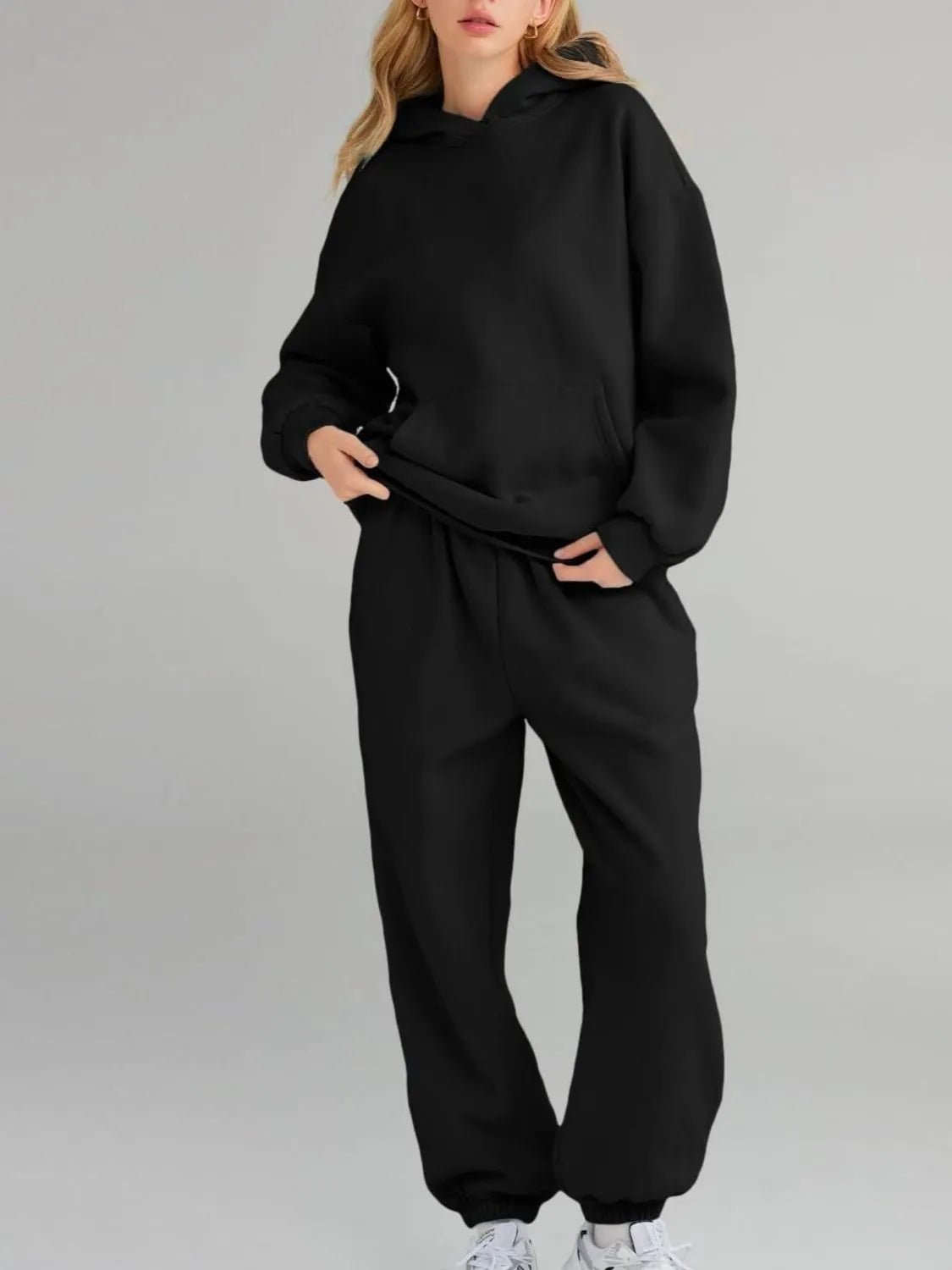 Plus size Tikibella™ full size hoodie and joggers set with a kangaroo pocket, displayed in a casual setting.