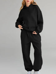 Plus size Tikibella™ full size hoodie and joggers set with a kangaroo pocket, displayed in a casual setting.