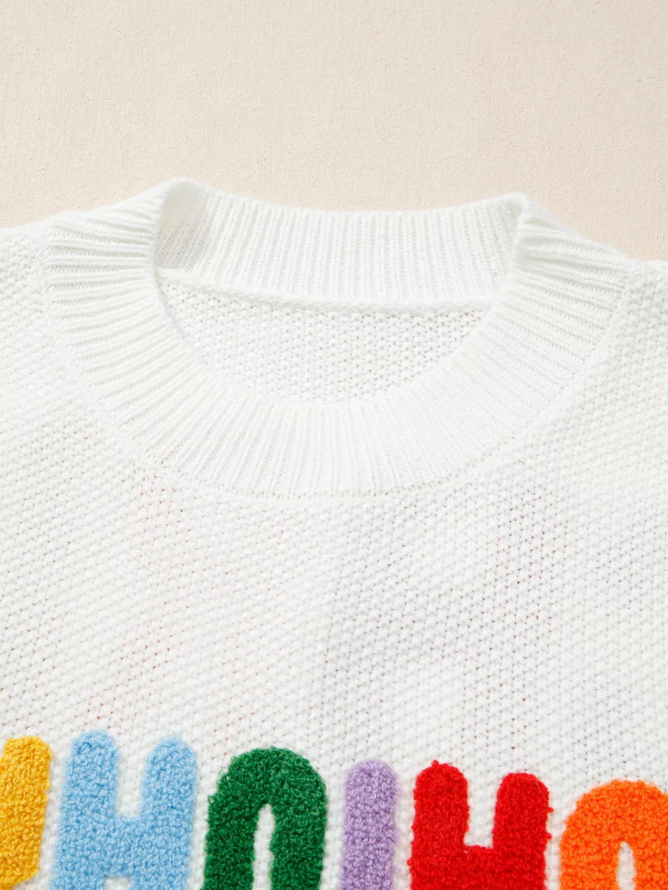 Drop shoulder holiday sweater featuring "HOHOHO MERRY CHRISTMAS" design by Tikibella™ in festive colors.