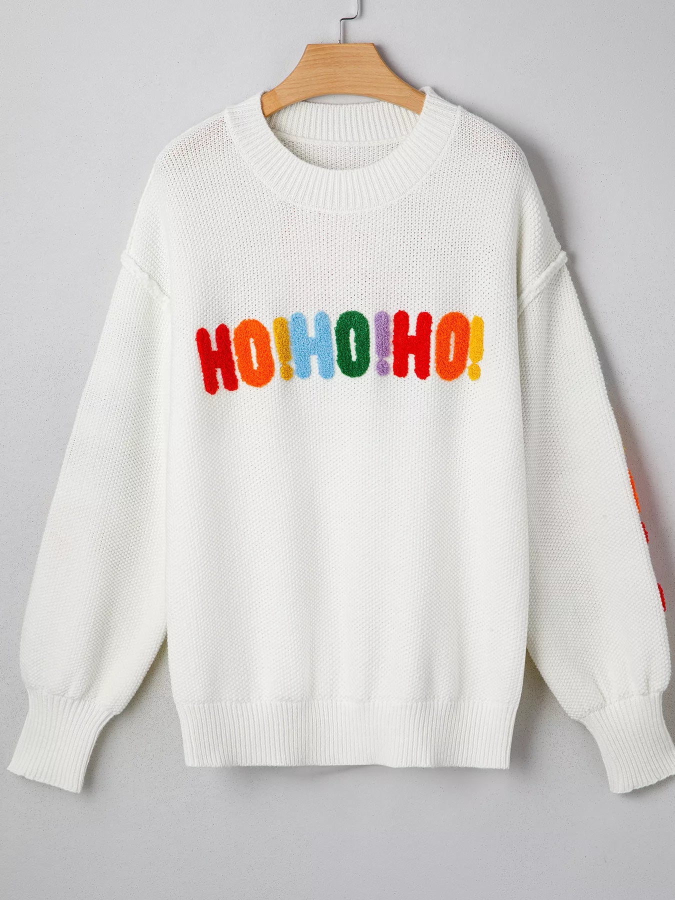 Tikibella™ HOHOHO MERRY CHRISTMAS drop shoulder holiday sweater in festive red with white lettering and relaxed fit.
