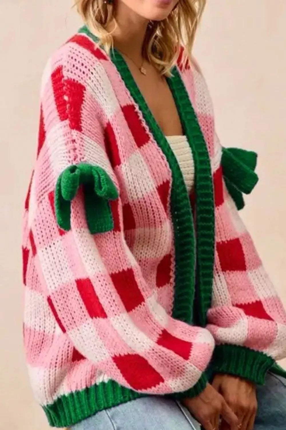 Checkered bow-tie sleeve knit Christmas cardigan by Tikibella™, featuring festive patterns and cozy design.