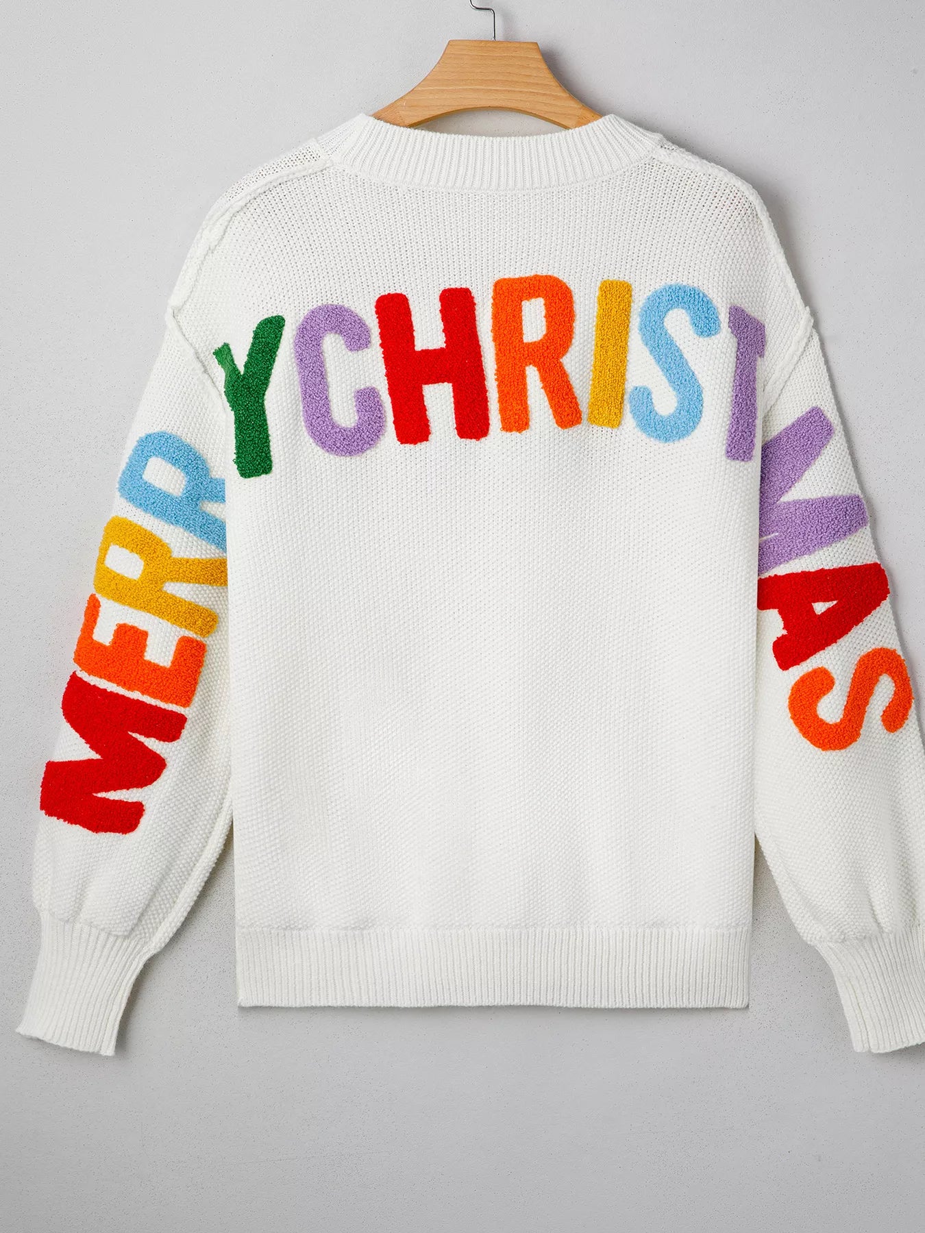 Drop shoulder holiday sweater featuring "HOHOHO MERRY CHRISTMAS" design by Tikibella™, perfect for festive occasions.